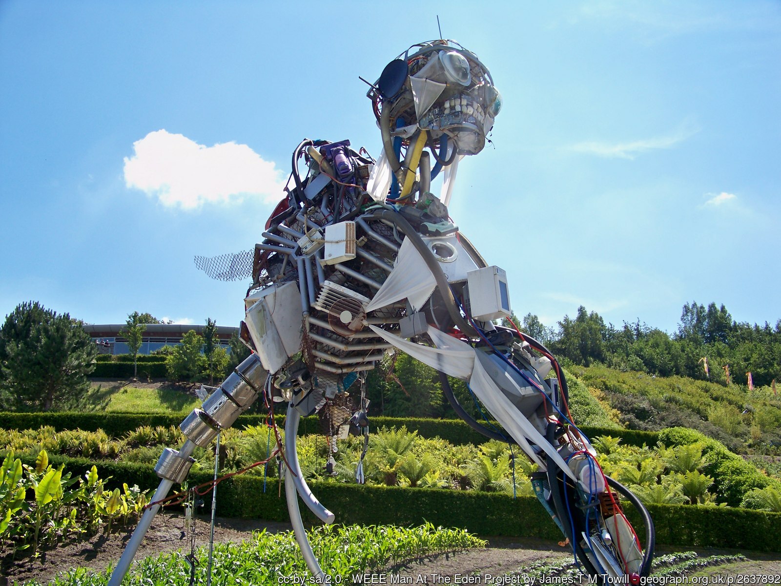 Image of “WEEE Man” statue, which is made from 3.3 metric tons of electrical waste, the average amount of e-waste that one UK individual creates in a lifetime. (Photograph by James T.M. Towill and <a href="https://www.geograph.org.uk/photo/2637892">published</a> under a <a href="https://spdx.org/licenses/CC-BY-SA-2.0.html">CC-BY-SA-2.0</a> license.)